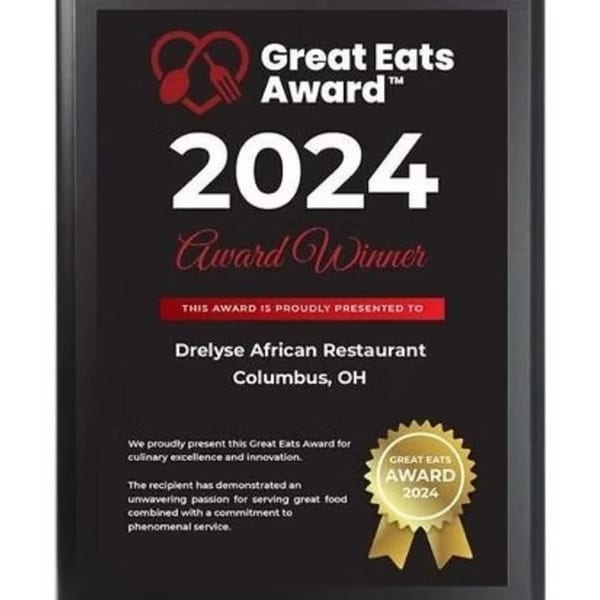 A black plaque displaying the 2024 Great Eats Award for Drelyse African Restaurant, Columbus, OH.