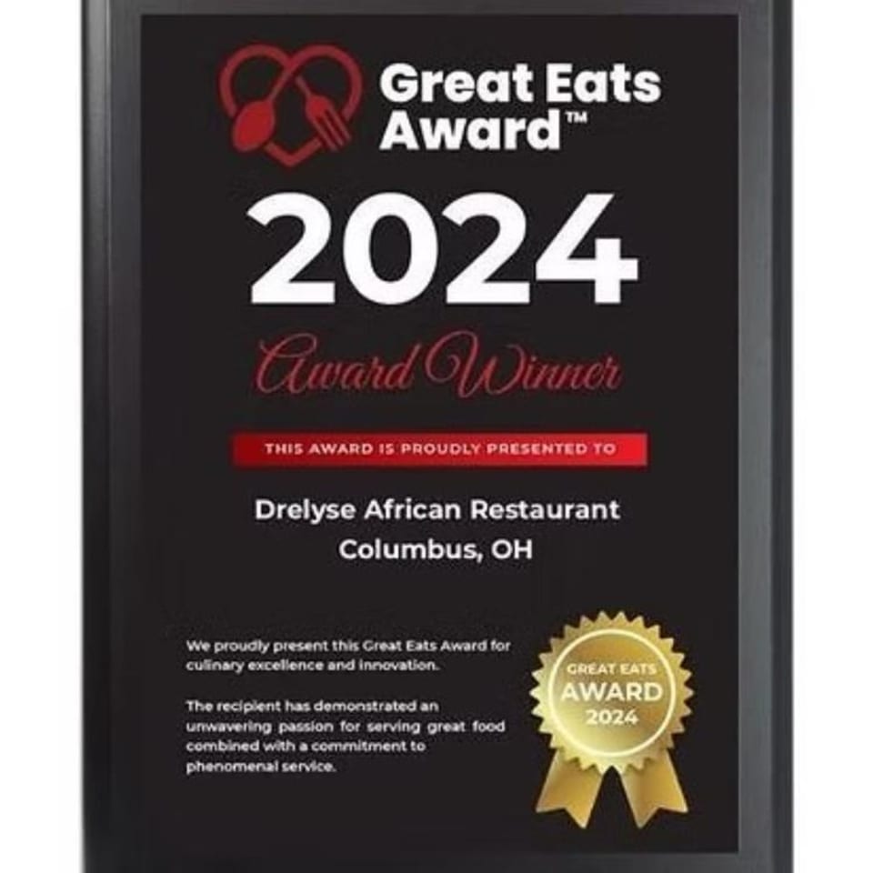 A black plaque displaying the 2024 Great Eats Award for Drelyse African Restaurant, Columbus, OH.