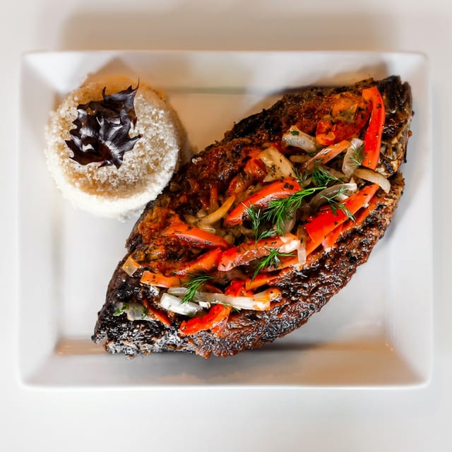 Atteike or White Rice and Tilapia Fish.